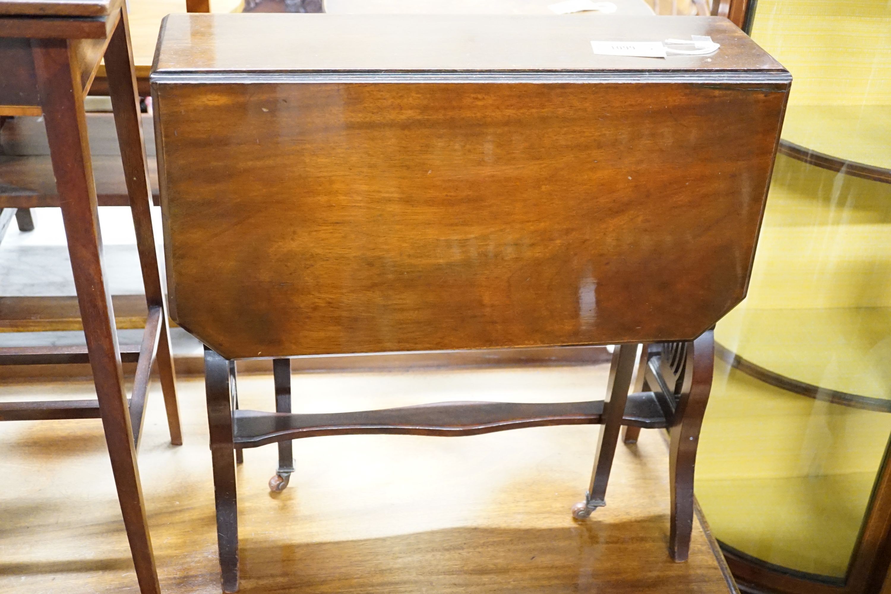 An Edwardian banded mahogany fold-over top table, 51 cm wide, 36 cm deep, 71.5 cm high and a mahogany Sutherland table